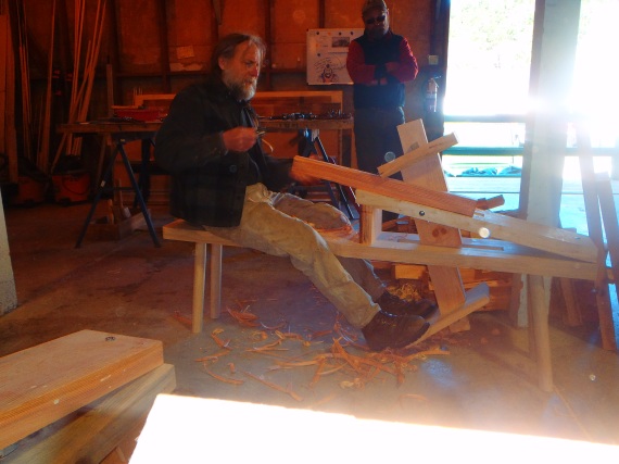Woodworking instructors, Steve and Greg, demonstrating how to use a drawknife and shave horse